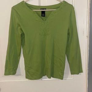 green long sleeve top with embroidery along the v neck collar